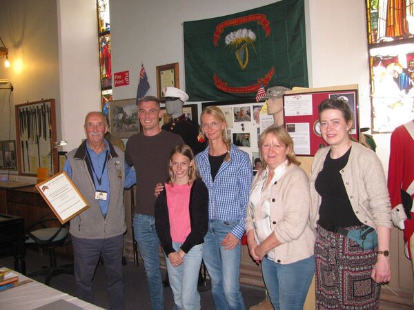 Paul Maguire, chairman of the Co Carlow Military Museum, presents Robby and Kathy Baker and their daugher with a memorial of Robby's father, Michael, alongside Teresa and Fiona Cunningham Photos: John Murphy 