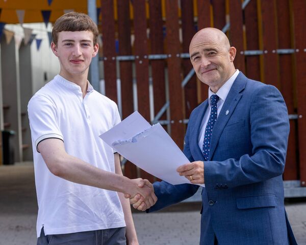 Will Owens looks receives his leaving cert results from John Maye, principal St Mary’s Knockbeg College Will Owens looks receives his leaving cert results from John Maye, principal St Mary’s Knockbeg College