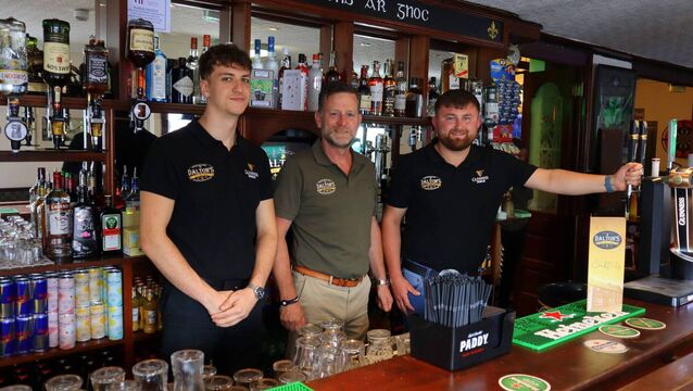 <p>Marko Emad, John Dalton and Keane Doyle at the bar of Dalton's on its official opening evening in Hacketstown</p>