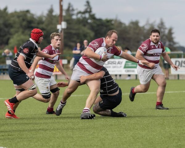Tullow's Scott Caldbeck tries to power past Kilkenny's Harry Prineas.
