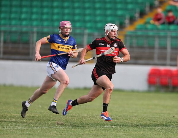 Dion Wall (Ballinkillen) chases after Chris Nolan (Mount Leinster Rangers)
