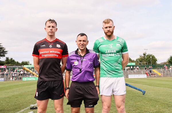 Mount Leinster Rangers captain Kevin McDonald his St Mullins counterpart Paul Doyle along with referee David Hickey ahead of the county final, both players made the Carlow Nationalist Team of the Championship Photo: Pat Ahern