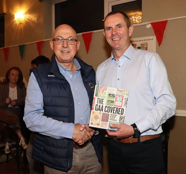 Carlow GAA Communication Officer Ger Doyle congratulates John Kelly at his book launch 