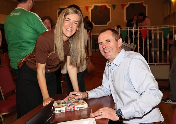 John Kelly signs a copy of his book for Deirdre Tomlinson