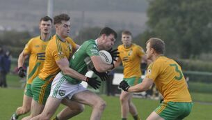 <p>No way out for Aran Teahan (Rathangan) as he is tackled by Tony O'Connor and Peter Kelly of Two Mile House.</p>