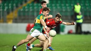 <p>Rathvilly's Brynn Nolan takes a shot with Palatine's John Byrne closing in.</p>