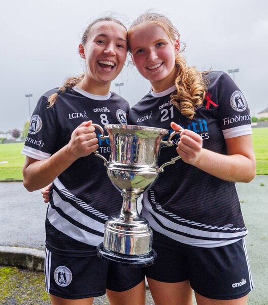 Fenagh’s Orlan Nolan and Orla Byrne proudly show off the Carlow LGFA Intermediate trophy Pic: © Michael O’Rourke Photography