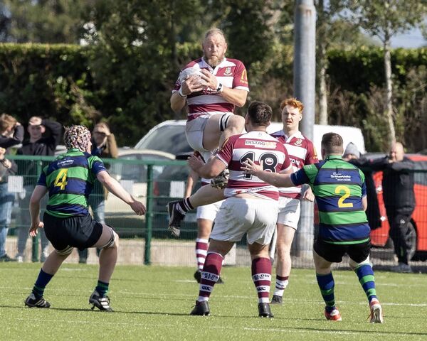 Tullow's Joe Waters wins this aerial battle with Seapoint's Hugh Ross.