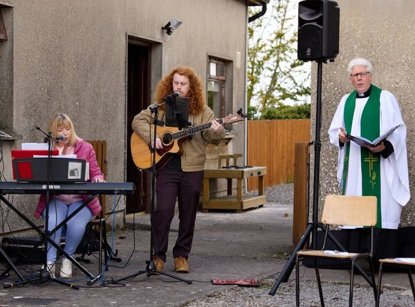 Rev Paul Fitzpatrick with musicians Olivia and Aaron Smyth at the blessing of the animals