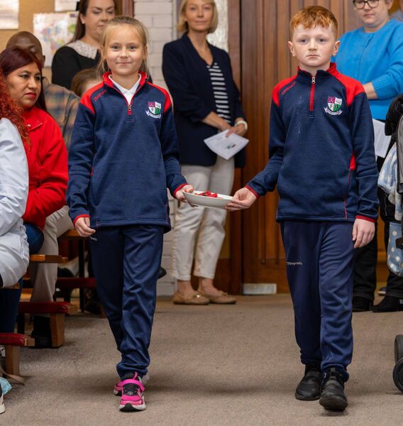 Pupils bringing symbols to the altar