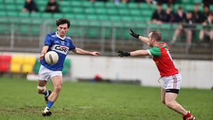 <p>Jamie Kenny from Palatine gets ready to try to block James Dowling's shot for a point. Photo: Pat Ahern</p>