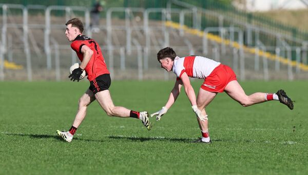 Ciarán Scott from Kildavin Clonegal gets away from Ballon's Jimmie Carroll.