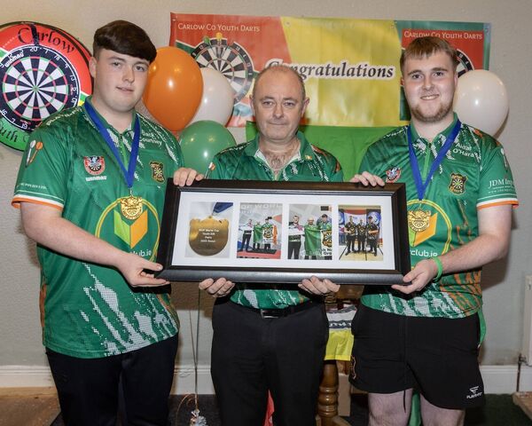 Irish International team manager Patrick Cullen (centre) receives a special prenentation from world champions Jack Courtney and Aidan O'Hara.