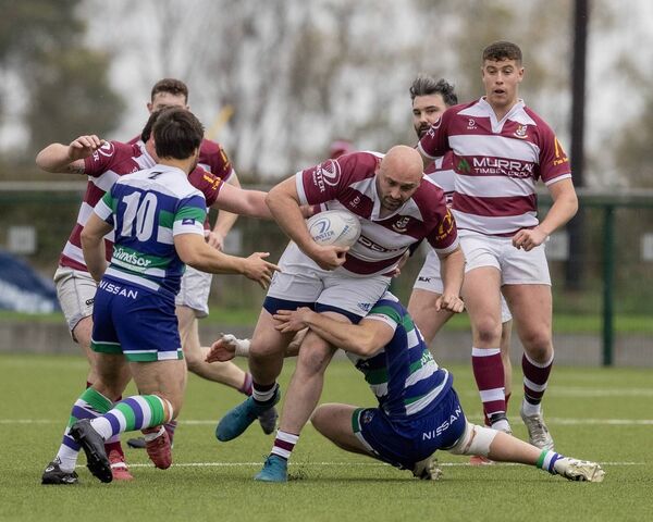 Tullow's Stephen Smith barrels over Suttonians' Joe Kelly. Tullow's Stephen Smith barrels over Suttonians' Joe Kelly.