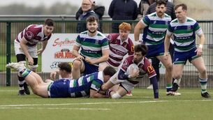 <p>Tullow's Ryan O'Neill is halted by Suttonians' Joe Kelly.</p>