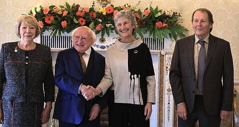 Hugs and handshakes as President Higgins welcomes his successor