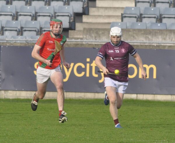 Aaron Amond carries the ball forward for Naomh Bríd