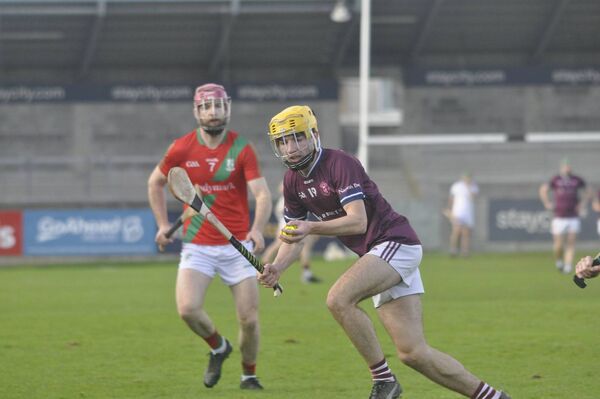 Jack Connolly (Naomh Bríd) wins the ball ahead of Conor McCarthy (Commercials)