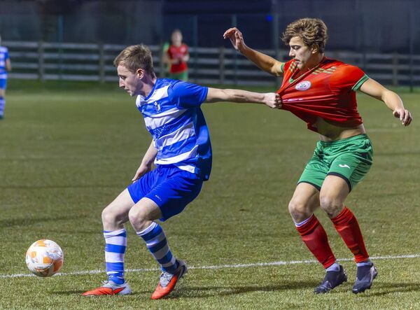St. Fiacc’s Jack Byrne grabs a fistful of St. Patrick’s Evan Frachon’s shirt in the box. Pic: © Michael O’Rourke Photography