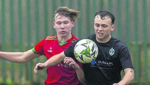 <p class="contextmenu internal_Caption">St. Patrick’s Jan Flejszar and New Oak’s Luke Ramsbottom in battle in their recent league tie.</p>