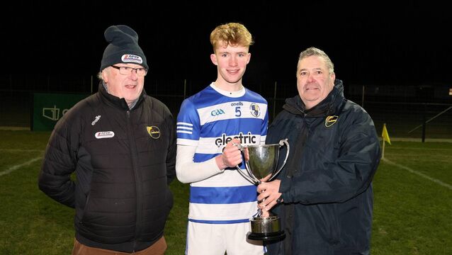<p>Tinryland captain Lorcan O'Connor receives the Stryve Under 21 FC 'B' final trophy from Carlow GAA Chairman John McDonald, with Michael Doran from Tinryland</p>