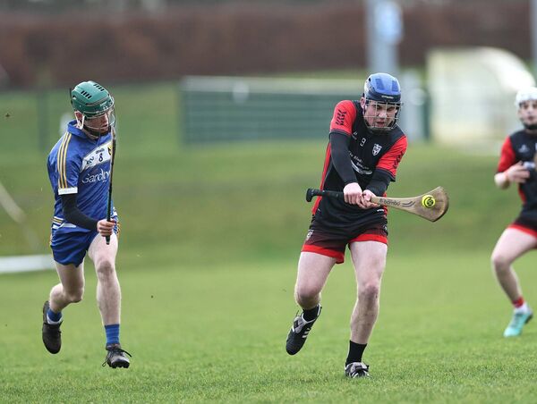 AJ Dooley (PDLS Bagealstown) drives the ball low with Rian Buttle from Carnew closing down the space.