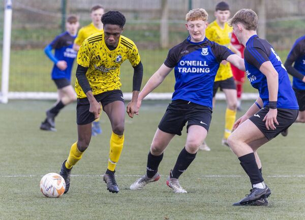 St. Fiacc’s Warith Oyeniyi takes on St. Joseph’s pair Sean McMahon and Jacob Curran.