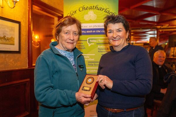 Móna Ní Liatháin, left, presenting the Glór Cheatharlach award to Máire Uí Hutáin in recognition of her years spent teaching traditional music to young people Móna Ní Liatháin, left, presenting the Glór Cheatharlach award to Máire Uí Hutáin in recognition of her years spent teaching traditional music to young people