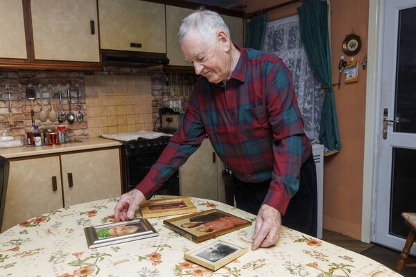 Dave with photos of loved ones lost to the disease. Pic: © Michael O'Rourke Photography 2026 Dave with photos of loved ones lost to the disease. Pic: © Michael O'Rourke Photography 2026