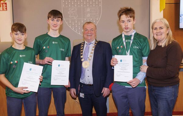 Cllr Ken Murnane presents a certificate of recognition to Paidi Breen, Patrick Cranny and Danny Donegan gold medalist in the U16 draughts event in the National Community Games. Also shown is their coach, Mairead Breen