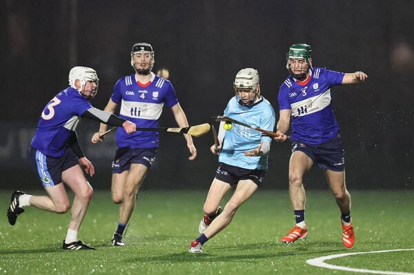 MTU Kerry's Aaron Gordon, who plays hurling with Burren Rangers, gets a nice tap on the ball off the stick of SETU Carlow's Kyle Nolan with Ethan Earle also lending his support.
