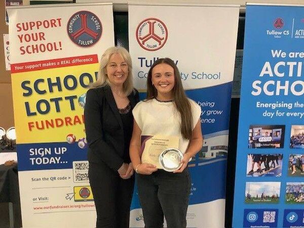 Katie Kinsella is presented with the Social Awareness Award by teacher Eimear Fitzgerald 