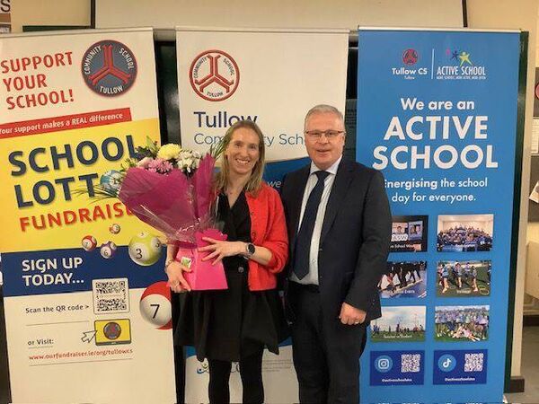 Principal Noel Murphy presenting guest speaker and past pupil Carol Coughlan with flowers as a token of thanks