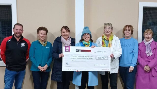 <p>Members of Clonegal Kildavin GAA gave a donation of €750 to Kildavin NS principal, Gillian Murphy</p>