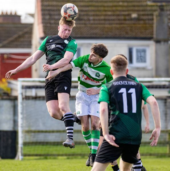 Hanover Harps' Brandon Cassidy wins a header above Burrin Celtic’s Dylan O’Reilly