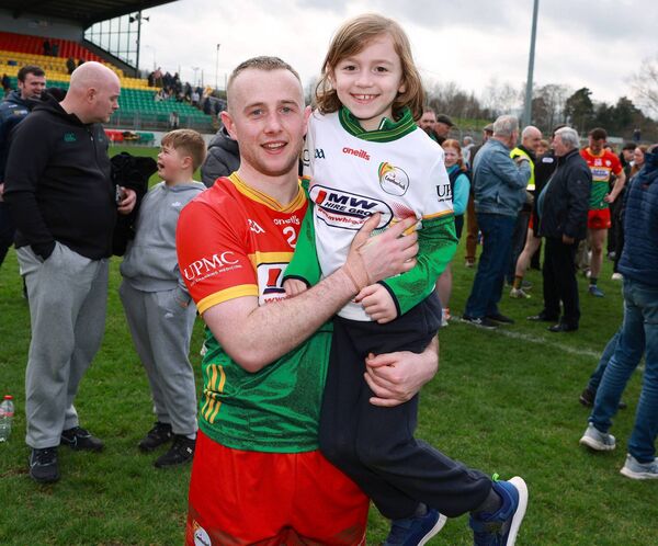 Carlow corner back Colin Byrne with Sam, enjoying Carlow's promotion