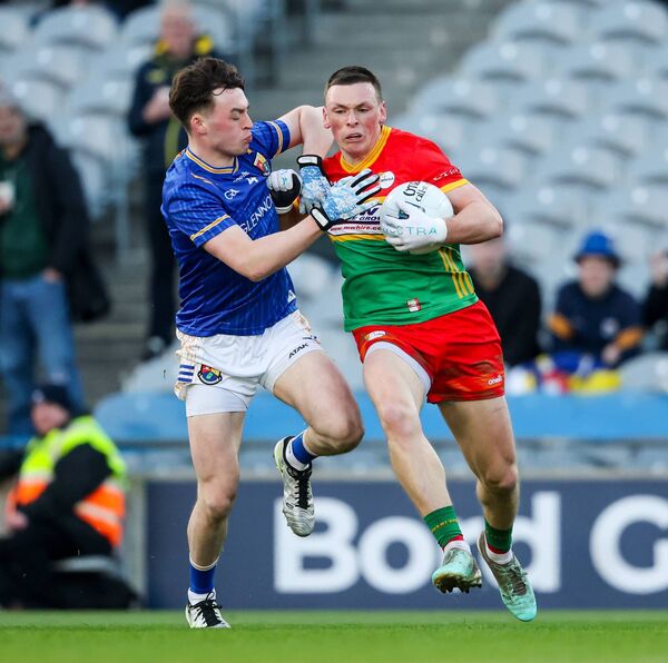Mikey Bambrick tries to hold off Longford's Bryan Masterson Photo: ©INPHO/Nick Elliott