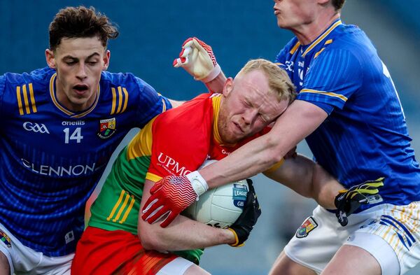 Carlow's Conor Doyle is tackled by Ronan Sweeney and Joseph Hagan of Longford Photo: ©INPHO/Nick Elliott Carlow's Conor Doyle is tackled by Ronan Sweeney and Joseph Hagan of Longford Photo: ©INPHO/Nick Elliott
