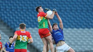 <p>Eoghan Ruth beats Dessie Reynolds to a kick out Photo: Pat Ahern</p>