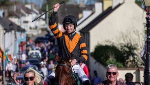 <p>Patrick Mullins rides Nick Rocket through the streets of Leighlinbridge at the welcome home for last year's Aintree Grand National winner</p>