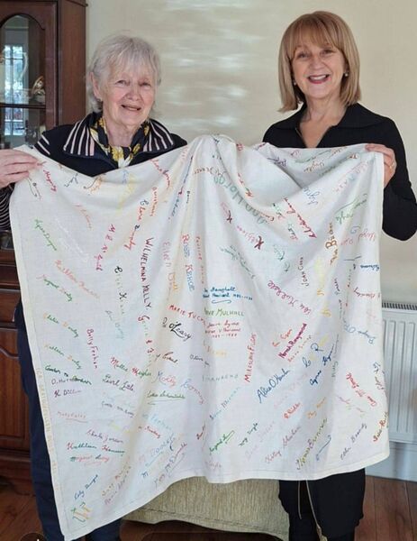 Carmel Dawson (left) accepts the quilt bearing the embroidered names of members of Graiguecullen ICA Guild between 1950 and 1991, including then National President Ina Broughall. Carmel received the quilt on behalf of the  Carlow Federation of ICA from Ina's daughter Aisling Farren, pictured on right