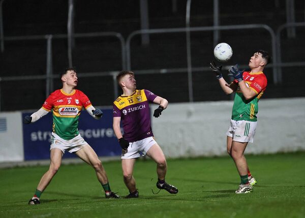 Carlow's captain Darragh Casey keeps his eye on the ball as he catches it with Carlow's Eoghan Treacy and Fergal Doyle watching on Photo: Pat Ahern