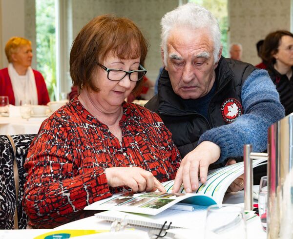 Mary and Michael O'Toole look over the catalogue on the 'Trees of Carlow' at the Pride of Place workshop