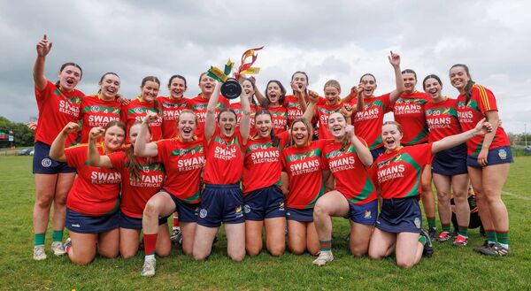 Carlow celebrate as captain Caoimhe Coady lifts the All-Ireland trophy. 