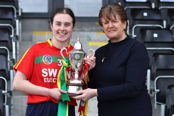 Carlow captain Caoimhe Coady presented with the All-Ireland trophy by 28th President of the camogie Association, Aileen Lawlor.