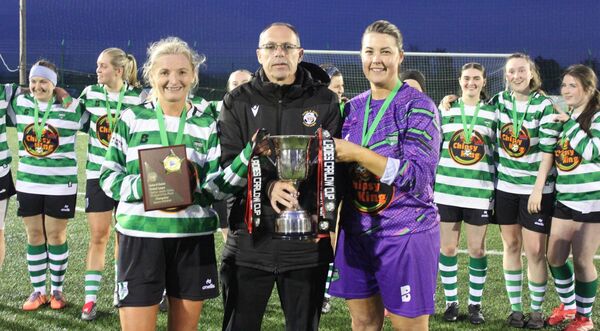 Brian O'Reilly, League Secretary, presenting the Carlow Cup to winning captains Geraldine Norton and Margaret Nolan.