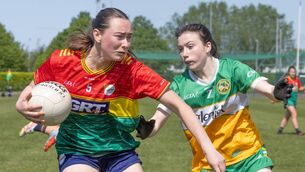 <p>Carlow’s Aoibhinn Webb tries to escape the grasp of Offaly’s Nicole Buckley. </p>