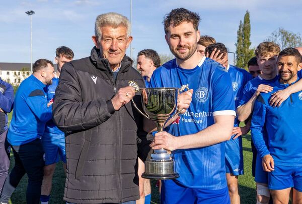 Noel Jordan, Hon Chairman Carlow &amp; District Football League, presents the Premier Cup to Bagenalstown captain Andrew Kane.