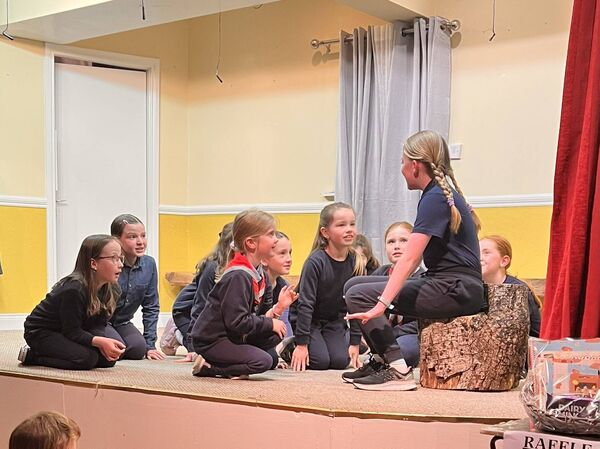 Grace Brennan as the Scoutmaster telling the scouts a story Grace Brennan as the Scoutmaster telling the scouts a story