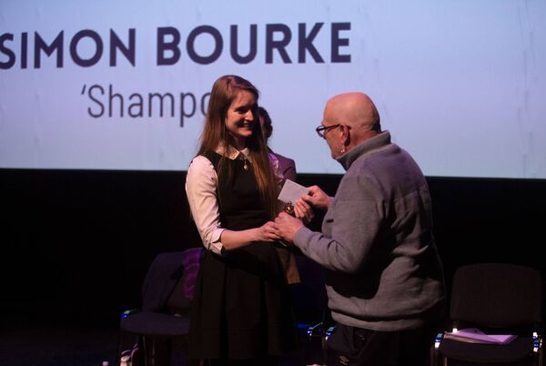Simon Bourke receives his award from poet Molly Twomey